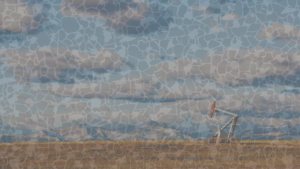 an oil derrick in the foreground and mountains in the background, overlaid with a chip used in ccs testing